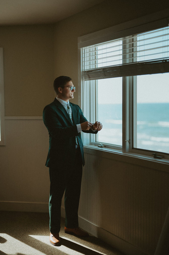 Groom getting ready at the reception venue, Camp Blodgett, in West Olive, Michigan on the shoreline of Lake Michigan 